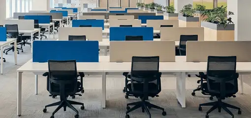 Modern open-plan office space featuring clean workstations, ergonomic chairs, and sanitized carpets provided by professional office cleaning services in Fort Wayne, IN.