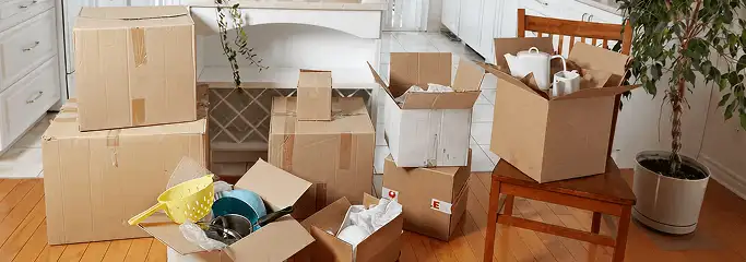 Packed moving boxes and household items in a kitchen before move-out or move-in cleaning, Fort Wayne, IN.